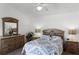 Primary bedroom with king bed, dresser, and ceiling fan at 1201 Winding Willow Ct, Kissimmee, FL 34746