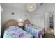 bedroom with twin beds, built in closet, and a view of another bedroom at 1201 Winding Willow Ct, Kissimmee, FL 34746