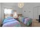Bright bedroom with twin beds, ample closet space, and neutral decor at 1201 Winding Willow Ct, Kissimmee, FL 34746