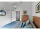 Primary bedroom with king bed, dresser, and access to bathroom at 1201 Winding Willow Ct, Kissimmee, FL 34746