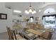 Open concept dining area with glass-top table and seating for six at 1201 Winding Willow Ct, Kissimmee, FL 34746