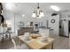 Bright dining area with light wood table and chairs, open to kitchen at 1201 Winding Willow Ct, Kissimmee, FL 34746