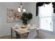 Cozy dining area with light wood table and four chairs, near a window at 1201 Winding Willow Ct, Kissimmee, FL 34746