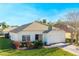 Front view of a single story house with a two-car garage and landscaping at 1201 Winding Willow Ct, Kissimmee, FL 34746