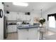 Kitchen with white cabinets, a breakfast bar, and stainless steel appliances at 1201 Winding Willow Ct, Kissimmee, FL 34746