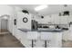 Modern kitchen with white cabinets, stainless steel appliances, and breakfast bar at 1201 Winding Willow Ct, Kissimmee, FL 34746