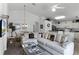 Comfortable living room with sectional sofa and large windows, open to kitchen at 1201 Winding Willow Ct, Kissimmee, FL 34746