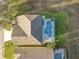 An aerial view showcasing a house, pool, and expansive grassy backyard at 124 Cassia Dr, Davenport, FL 33897