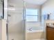 Bathroom with shower, bathtub, and double vanity at 124 Cassia Dr, Davenport, FL 33897