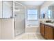 Bathroom with shower, bathtub, and double vanity at 124 Cassia Dr, Davenport, FL 33897
