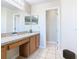 Clean bathroom with a single vanity and access to another room at 124 Cassia Dr, Davenport, FL 33897