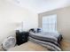Bedroom with striped bedding and a dark dresser at 124 Cassia Dr, Davenport, FL 33897
