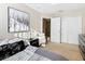 Bedroom with gray bedding, chair, and large closet at 124 Cassia Dr, Davenport, FL 33897