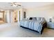 Primary bedroom with king-size bed and en-suite bathroom access at 124 Cassia Dr, Davenport, FL 33897