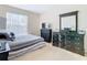 Bedroom with striped bedding and a large dresser at 124 Cassia Dr, Davenport, FL 33897