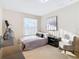 Bedroom with gray bedding, chair, and large closet at 124 Cassia Dr, Davenport, FL 33897
