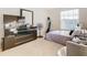 Bright bedroom with a large window, dresser, and comfortable bed at 124 Cassia Dr, Davenport, FL 33897