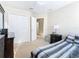 Bedroom with double doors to closet and adjoining bathroom at 124 Cassia Dr, Davenport, FL 33897