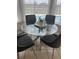 Bright dining area with glass table and four gray chairs, overlooking pool at 124 Cassia Dr, Davenport, FL 33897