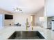 Modern kitchen with a large island, stainless steel sink, and gold faucet at 124 Cassia Dr, Davenport, FL 33897