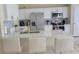 Modern kitchen with white cabinets, stainless steel appliances, and breakfast bar at 124 Cassia Dr, Davenport, FL 33897