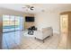Living room with tiled floors, gray couch, and sliding doors leading to the pool at 124 Cassia Dr, Davenport, FL 33897
