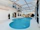 Refreshing pool with screened enclosure and home view at 124 Cassia Dr, Davenport, FL 33897