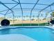 Inviting kidney-shaped pool with screened patio at 124 Cassia Dr, Davenport, FL 33897