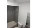 Updated bathroom with gray tile, a bathtub, and a vanity at 13803 Fairway Island Dr # S, Orlando, FL 32837