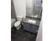 Bathroom with gray vanity, dark-gray floor tile, and a white sink at 13803 Fairway Island Dr # S, Orlando, FL 32837