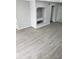Bright living room featuring gray vinyl flooring and built-in shelving at 13803 Fairway Island Dr # S, Orlando, FL 32837