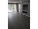 Living room with gray vinyl flooring, sliding doors, and a built-in shelf at 13803 Fairway Island Dr # S, Orlando, FL 32837