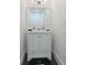 Clean bathroom with white vanity, large mirror, and dark floor tile at 152 Pinewood Dr, Davenport, FL 33896