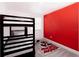 Mickey Mouse themed bedroom with a bunk bed and red accent wall at 152 Pinewood Dr, Davenport, FL 33896