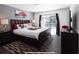 Main bedroom with a king-size bed, dark dresser, and access to the pool at 152 Pinewood Dr, Davenport, FL 33896