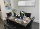 Dining area with marble table, black leather chairs, and stylish decor at 152 Pinewood Dr, Davenport, FL 33896