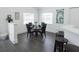 Small dining area with glass table, four chairs, and modern decor at 152 Pinewood Dr, Davenport, FL 33896