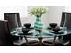 Close-up of round glass dining table with place settings at 152 Pinewood Dr, Davenport, FL 33896