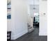 Clean hallway with dark tile floors and staircase to upper level at 152 Pinewood Dr, Davenport, FL 33896