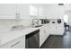 Modern kitchen with white cabinets, quartz countertops, and stainless steel appliances at 152 Pinewood Dr, Davenport, FL 33896