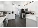 Modern kitchen with white cabinets, stainless steel appliances, and a breakfast bar at 152 Pinewood Dr, Davenport, FL 33896