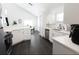 Modern kitchen with white cabinets, stainless steel appliances, and dark tile floors at 152 Pinewood Dr, Davenport, FL 33896