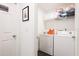 Bright laundry room with washer, dryer, and shelving at 152 Pinewood Dr, Davenport, FL 33896