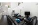 Spacious living room with black leather furniture and a large TV at 152 Pinewood Dr, Davenport, FL 33896