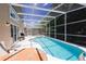 Relaxing screened pool and spa with patio furniture at 152 Pinewood Dr, Davenport, FL 33896