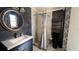 Contemporary bathroom boasting a sink with a white countertop, a sleek shower, and dark slate tiling at 1592 Martin Luther King Ne Blvd, Winter Haven, FL 33881