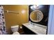 Cozy bathroom featuring a sink with a faux marble countertop, decorative mirror, and muted color scheme at 1592 Martin Luther King Ne Blvd, Winter Haven, FL 33881
