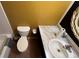 Clean bathroom with toilet and sink. Features a large mirror at 1592 Martin Luther King Ne Blvd, Winter Haven, FL 33881
