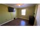 This bedroom features laminate flooring, a ceiling fan, a window, and a closet for storage at 1592 Martin Luther King Ne Blvd, Winter Haven, FL 33881