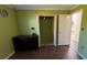 Cozy bedroom offering a closet, laminate floors, neutral walls, and access to adjacent rooms at 1592 Martin Luther King Ne Blvd, Winter Haven, FL 33881